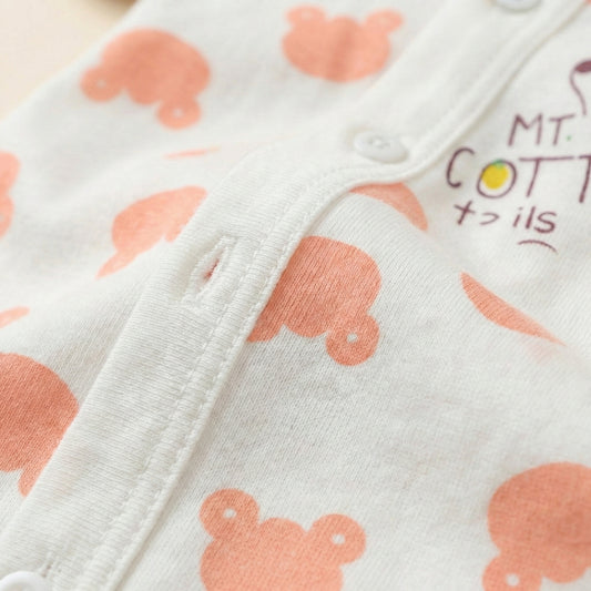 Close-up of a baby outfit with orange animal prints on a white background