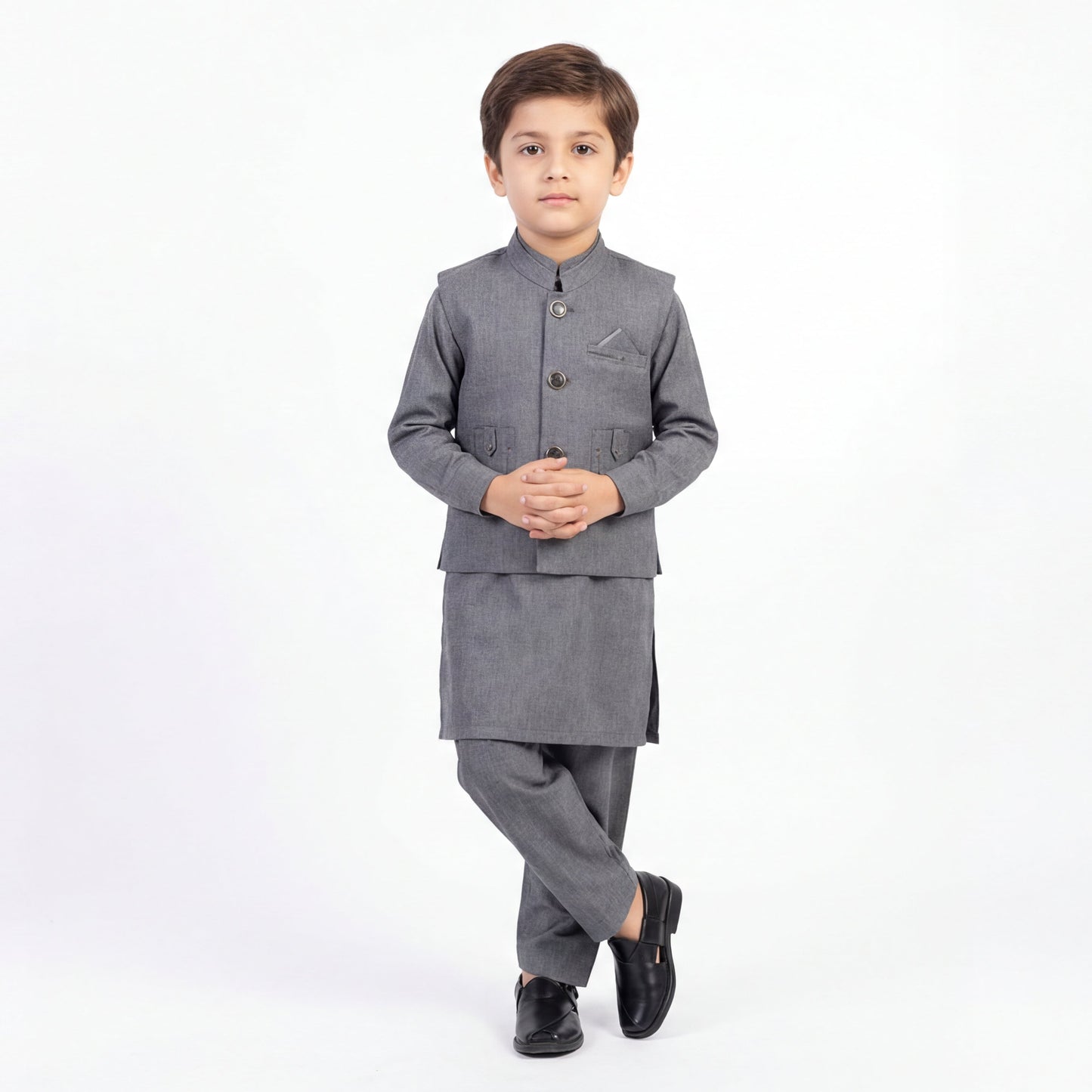 Young boy wearing a gray traditional outfit on a white background
