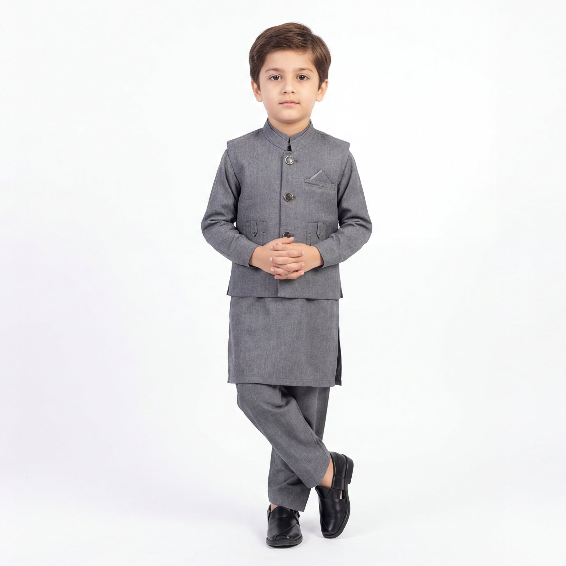 Young boy wearing a gray traditional outfit on a white background