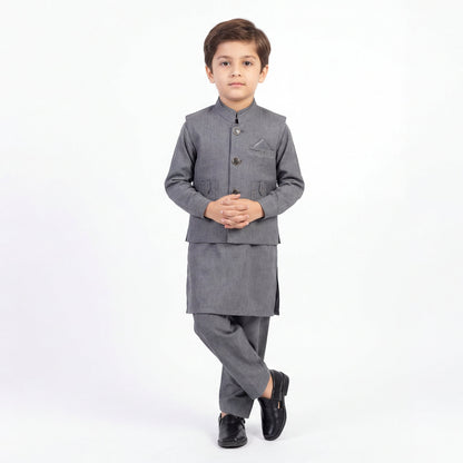 Young boy wearing a gray traditional outfit on a white background
