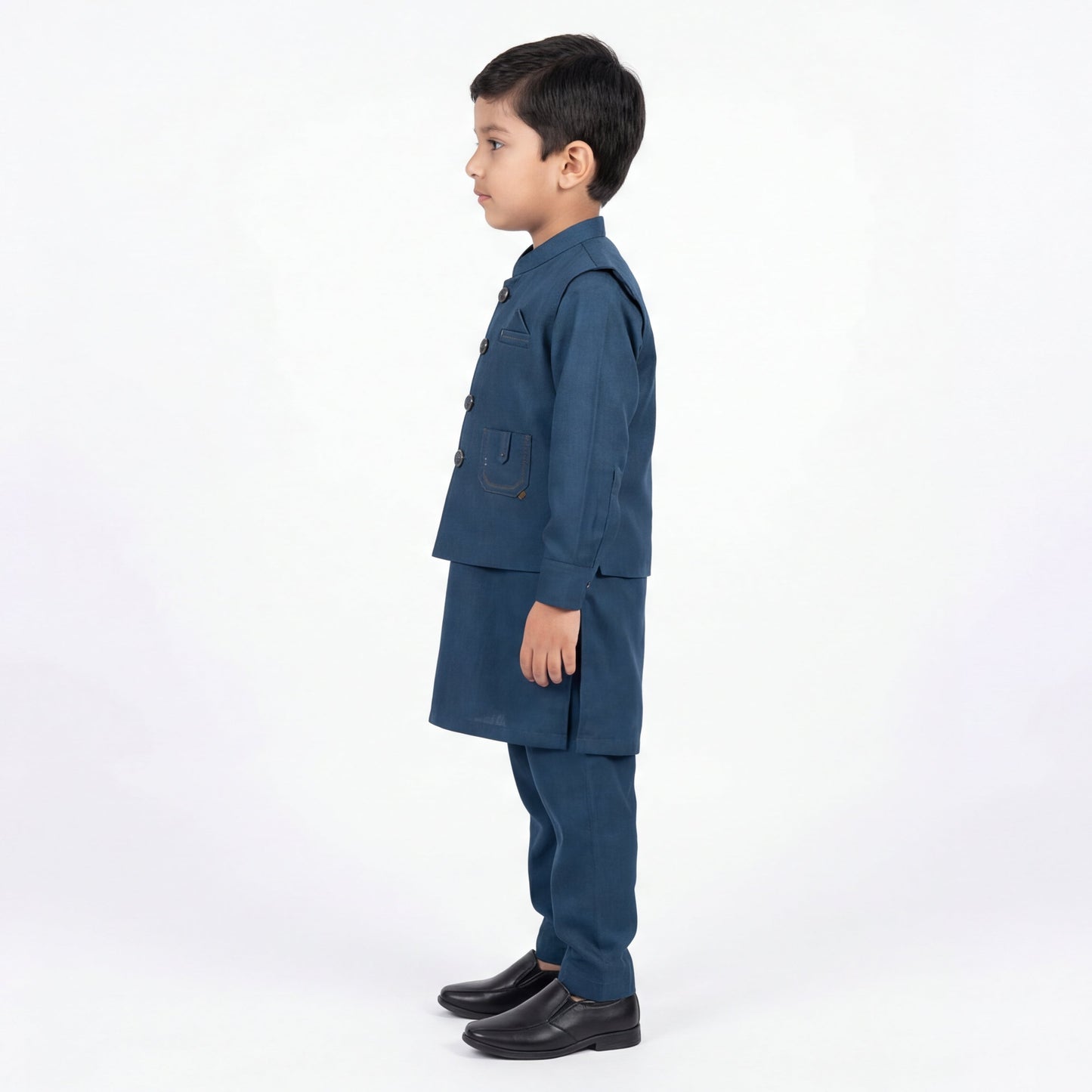Child wearing a blue suit standing against a white background