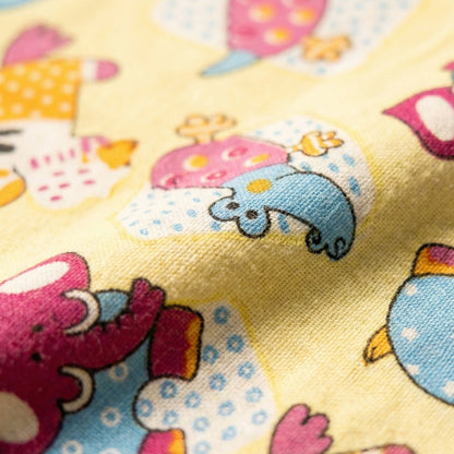 Colorful fabric with cartoon animal designs on a yellow background