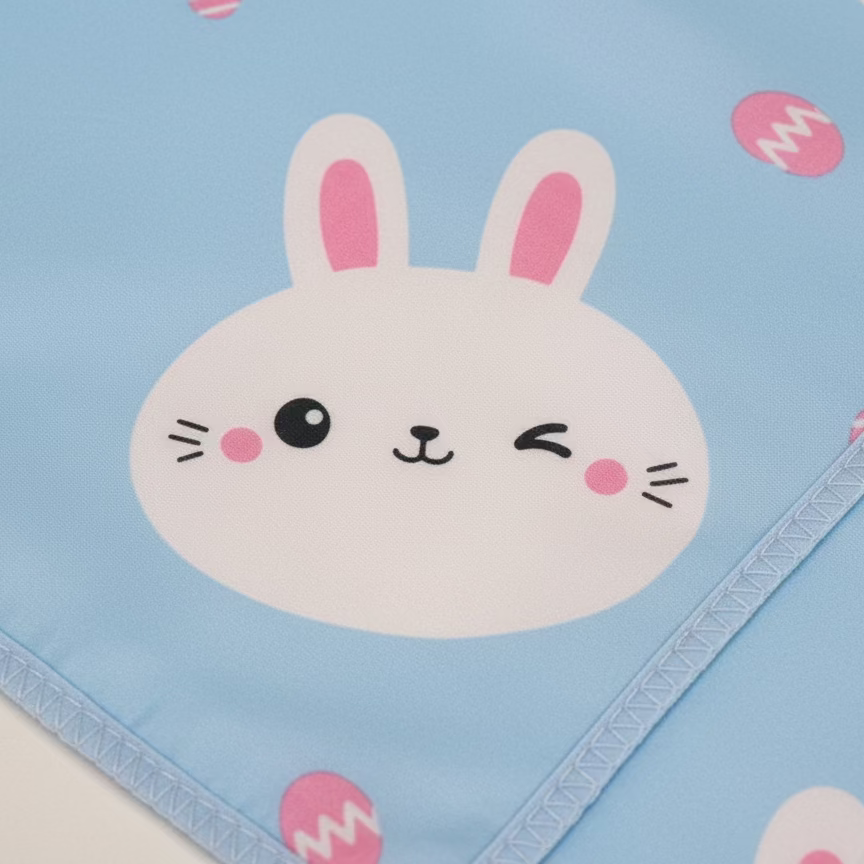 Children's blanket with a cartoon bunny face on a blue background