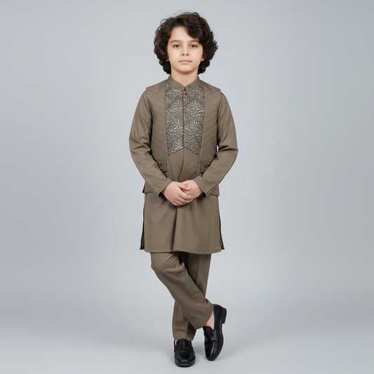 Child wearing a brown traditional outfit with intricate patterns on a gray background