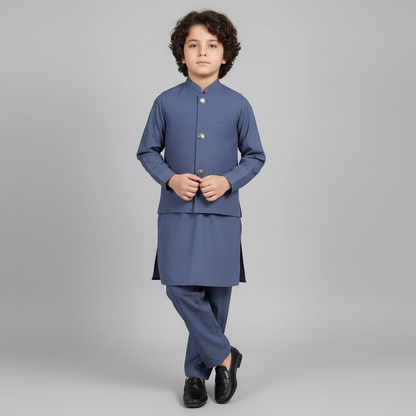 Child wearing a blue traditional outfit on a gray background
