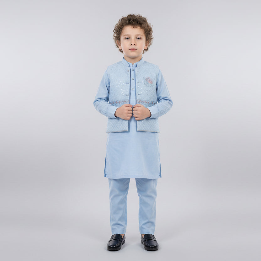 Child wearing a light blue traditional outfit on a white background