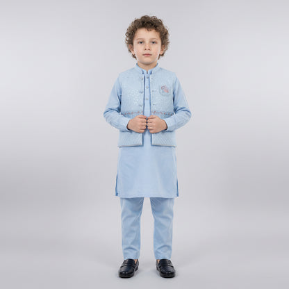 Child wearing a light blue traditional outfit on a white background