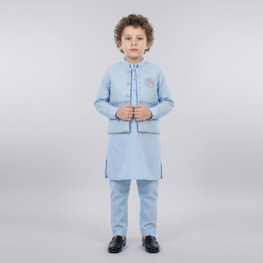 Child wearing a light blue traditional outfit on a white background