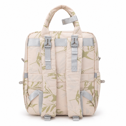 Beige botanical print mother and baby diaper backpack back view with padded straps