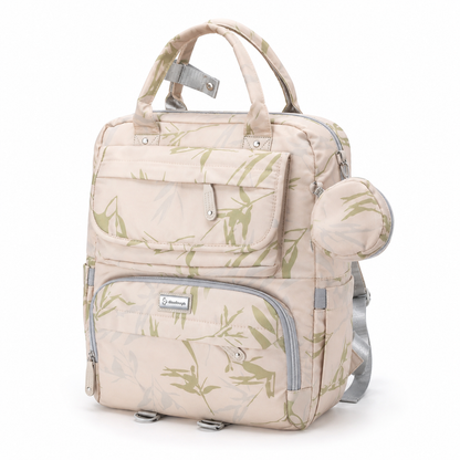 Beige botanical print mother and baby diaper backpack front three-quarter view with round accessory pouch