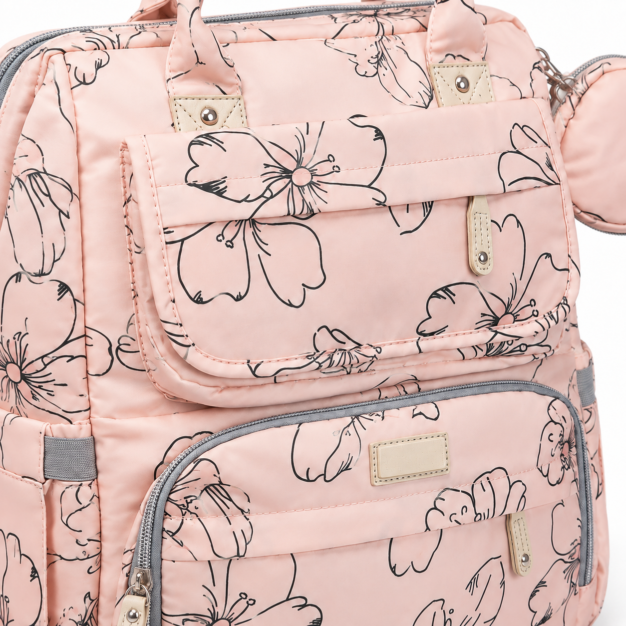 Blush pink floral mother and baby diaper backpack close-up showing pockets and stitching