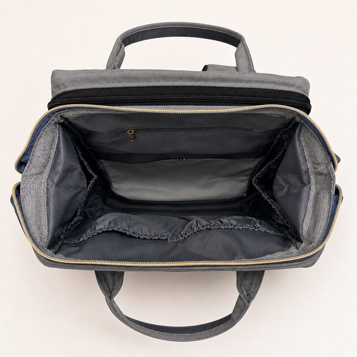 Empty organized interior of charcoal grey mother and baby backpack