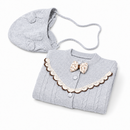 Gray cable knit baby romper set folded presentation with matching bonnet