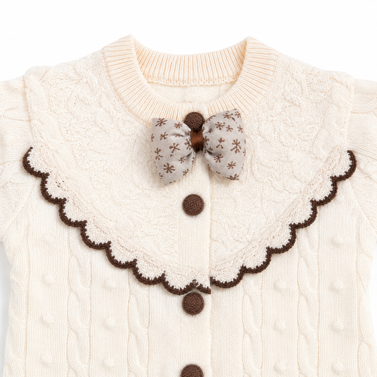 Ivory cable knit baby romper scalloped collar bow and button detail