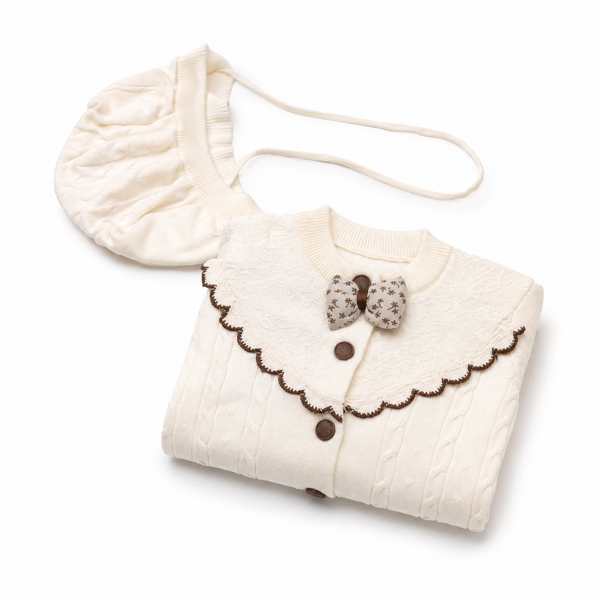 Ivory cable knit baby romper set folded presentation view with matching bonnet