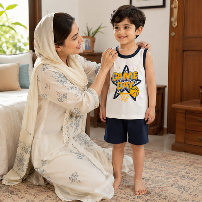 Mother helping child wearing kids game day sleeveless shirt and shorts set