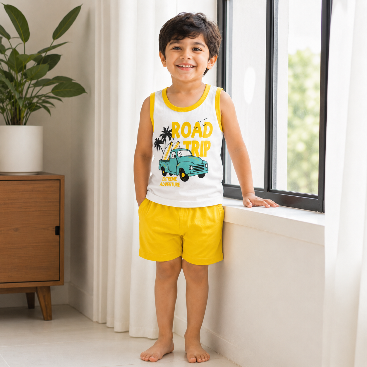 Pakistani child wearing kids road trip sleeveless shirt and shorts set near window