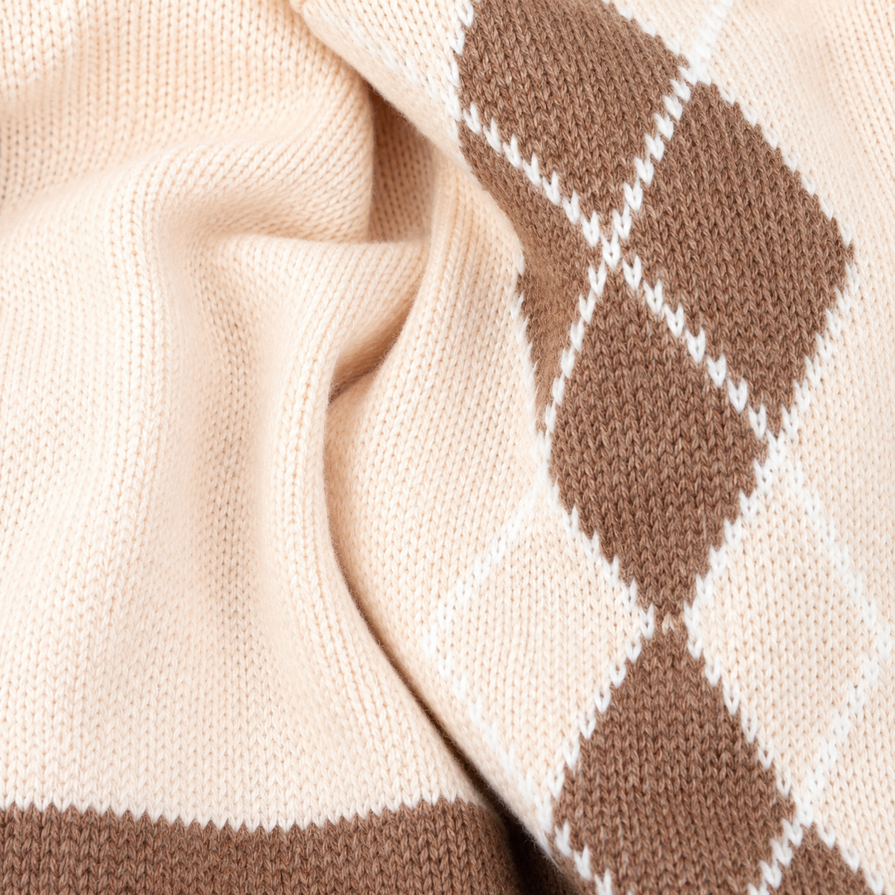 Knitted argyle baby romper fabric texture detail
