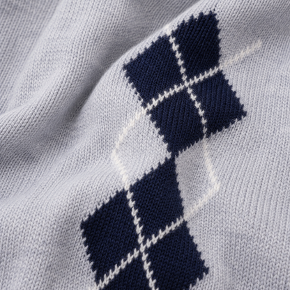 Navy and grey knitted argyle baby romper fabric texture close-up
