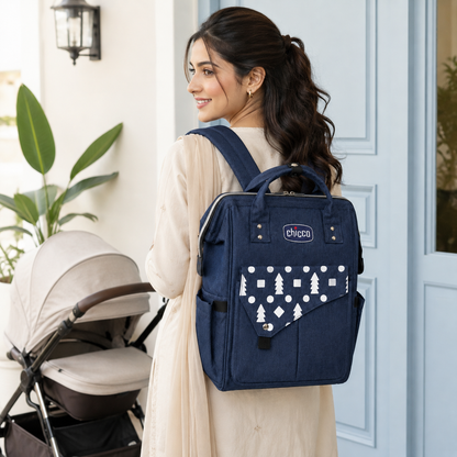 Pakistani mother wearing navy mother and baby backpack