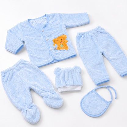 Blue newborn plush baby clothing set angled flat lay product photo