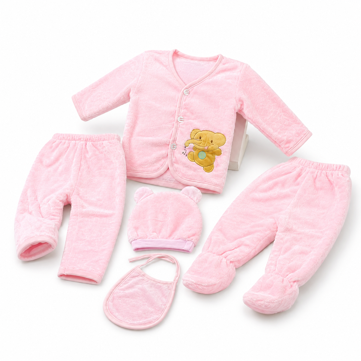 Pink newborn plush baby clothing set lifestyle studio arrangement