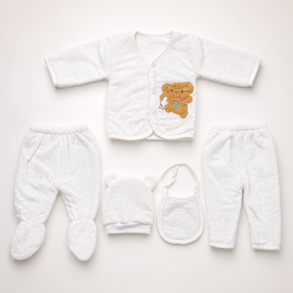 White newborn plush baby clothing set flat lay on soft gradient background