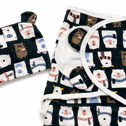 Navy bear print swaddle wrap and matching cap flat lay