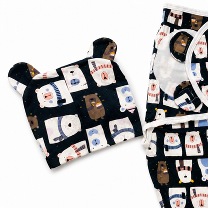Navy bear print swaddle wrap folded with matching cap