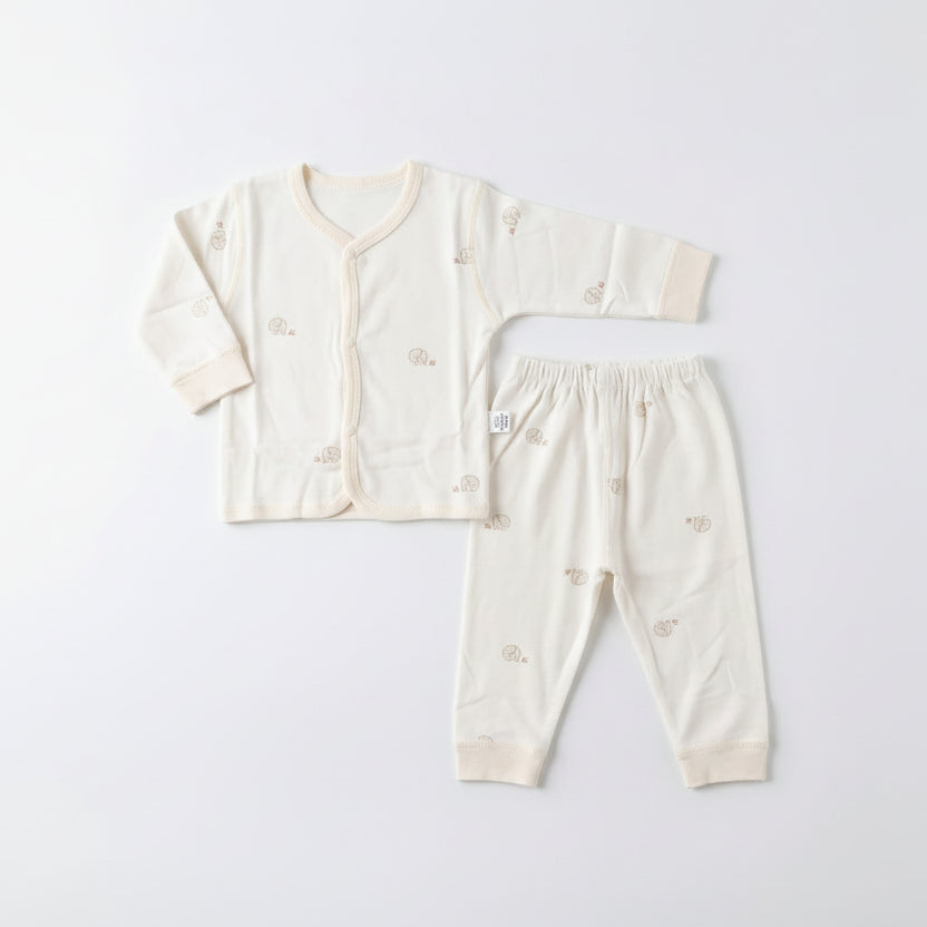 Baby outfit set with long-sleeve shirt, pants, and hat on a light gray background